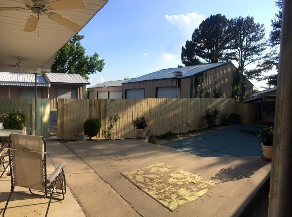Long run of new wood privacy fence with walk gate