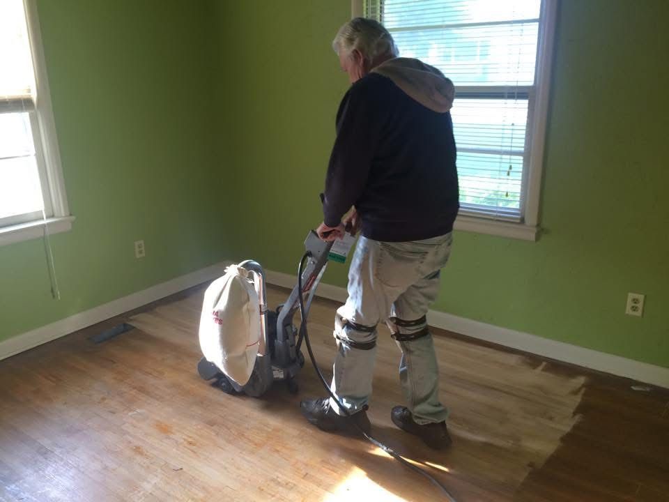 Patriot crew member sanding a hardwood floor