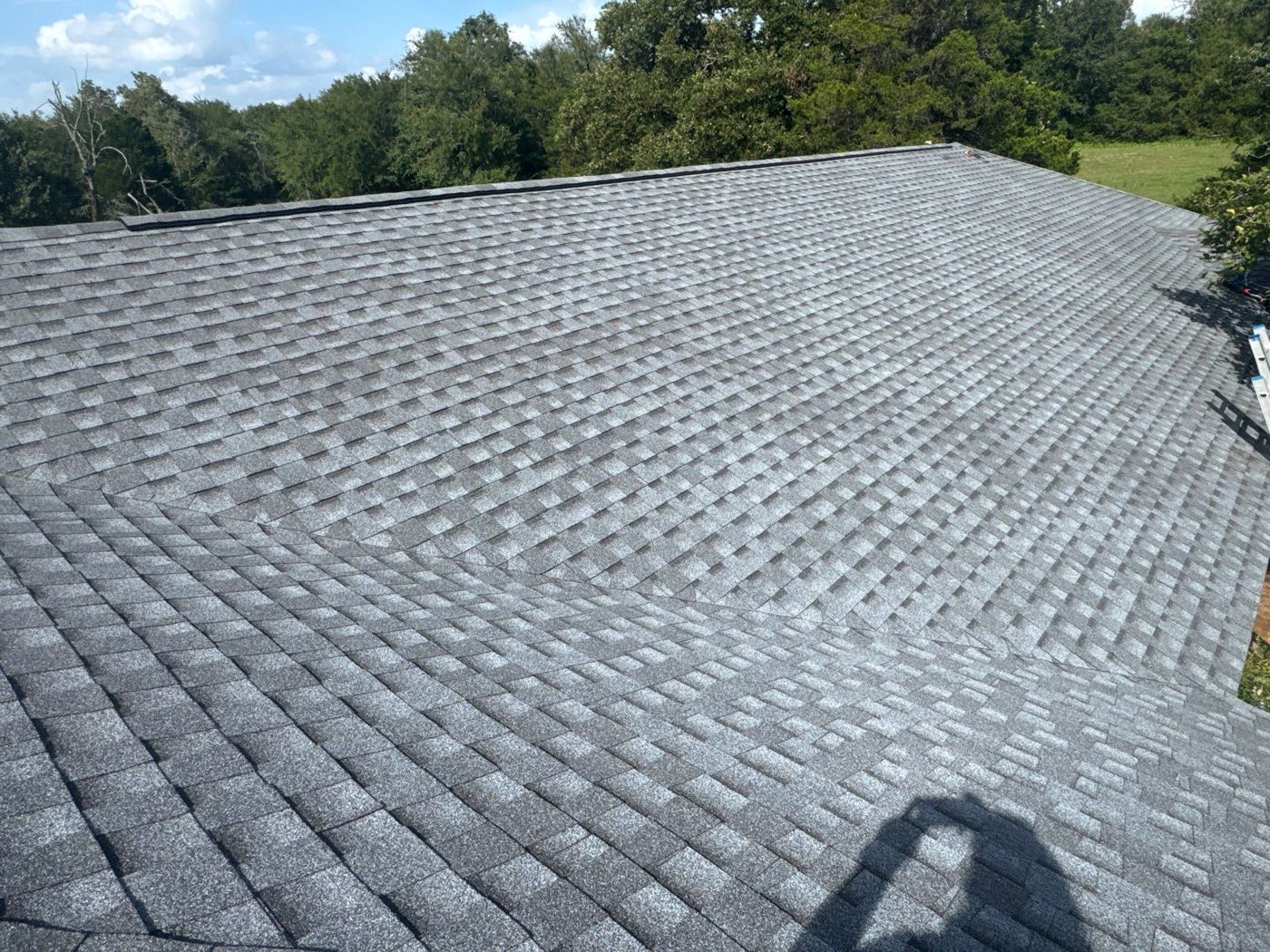 Newly installed gray architectural shingle roof