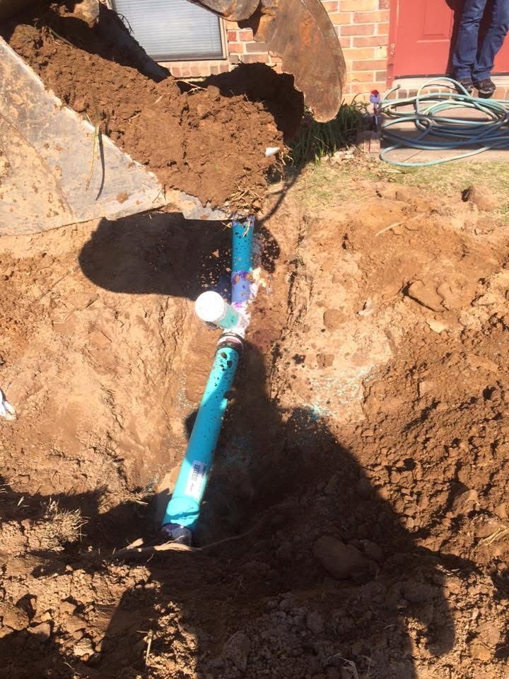 Excavated sewer line with new pipe installed
